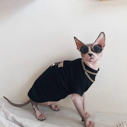 A stylish cotton sweater with a vibrant printed design and a coordinating necklace accessory, perfect for keeping your cat warm and fashionable.
