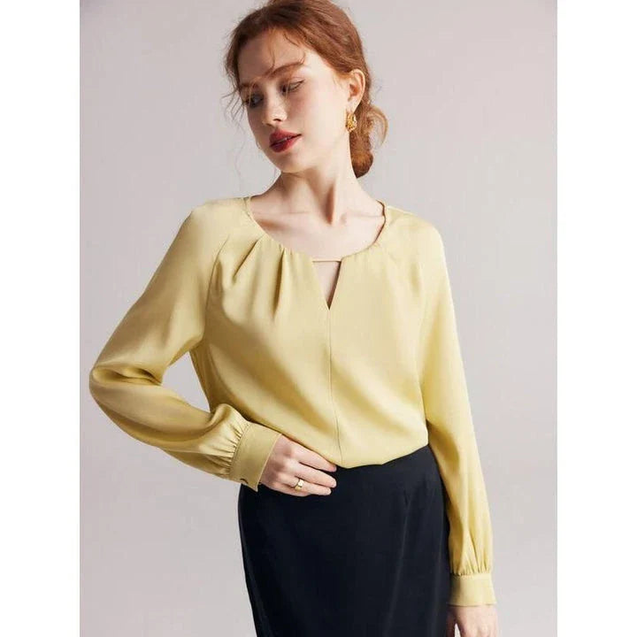 Elegant silk-blend blouse with raglan sleeves, featuring a timeless design and unique hollow-out details