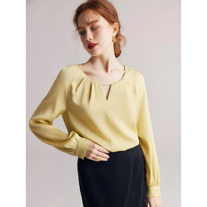 Elegant silk-blend blouse with raglan sleeves, featuring a timeless design and unique hollow-out details