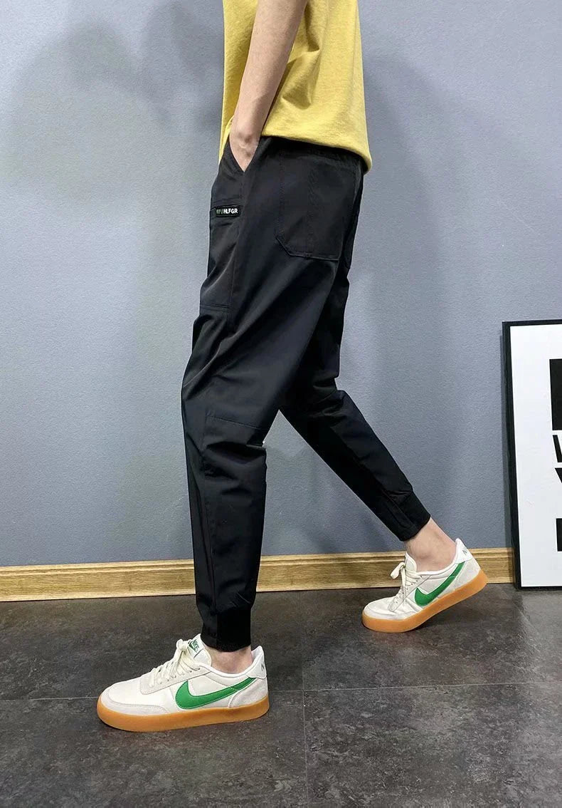 Premium slim-fit drawstring joggers in black and grey, featuring a tailored silhouette and adjustable waistband for a polished, comfortable look.