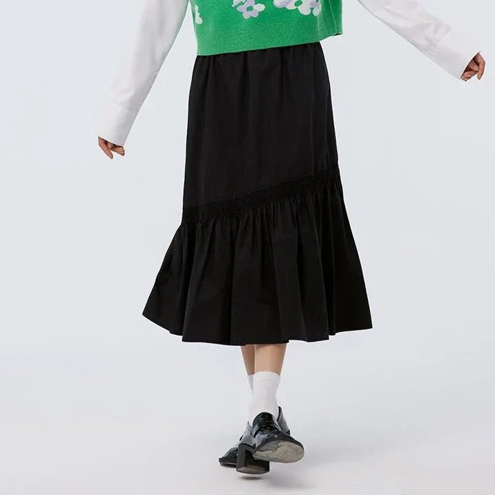 Elegant mid-length black skirt with an A-line silhouette, natural waistline, and unique irregular hemline, perfect for the modern British woman's wardrobe