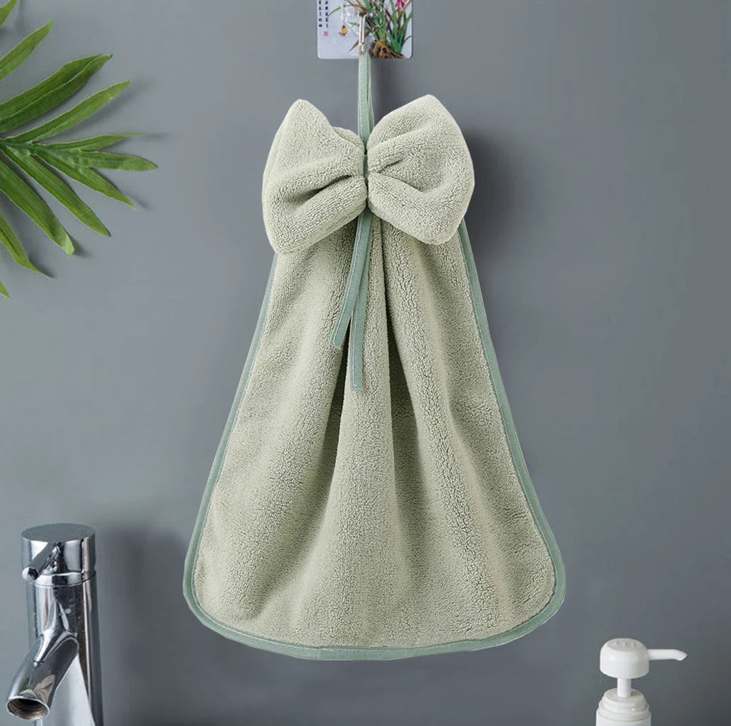 Elegant coral fleece hand towels with a unique bow design, perfect for kitchen and bathroom use