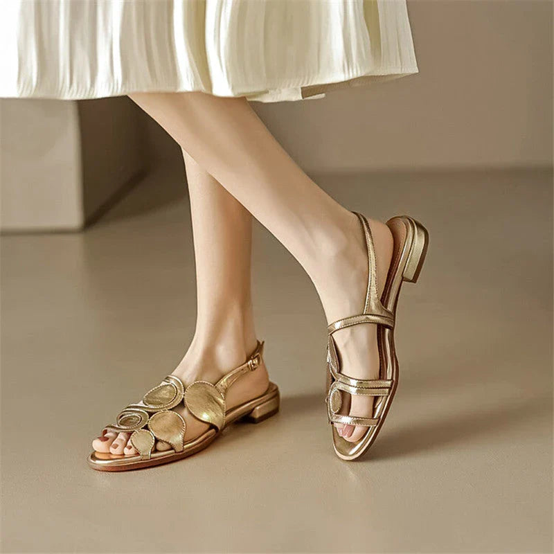 Chic sheepskin round toe sandals with a chunky heel and hollow out design, featuring a secure back strap and a modern, versatile style
