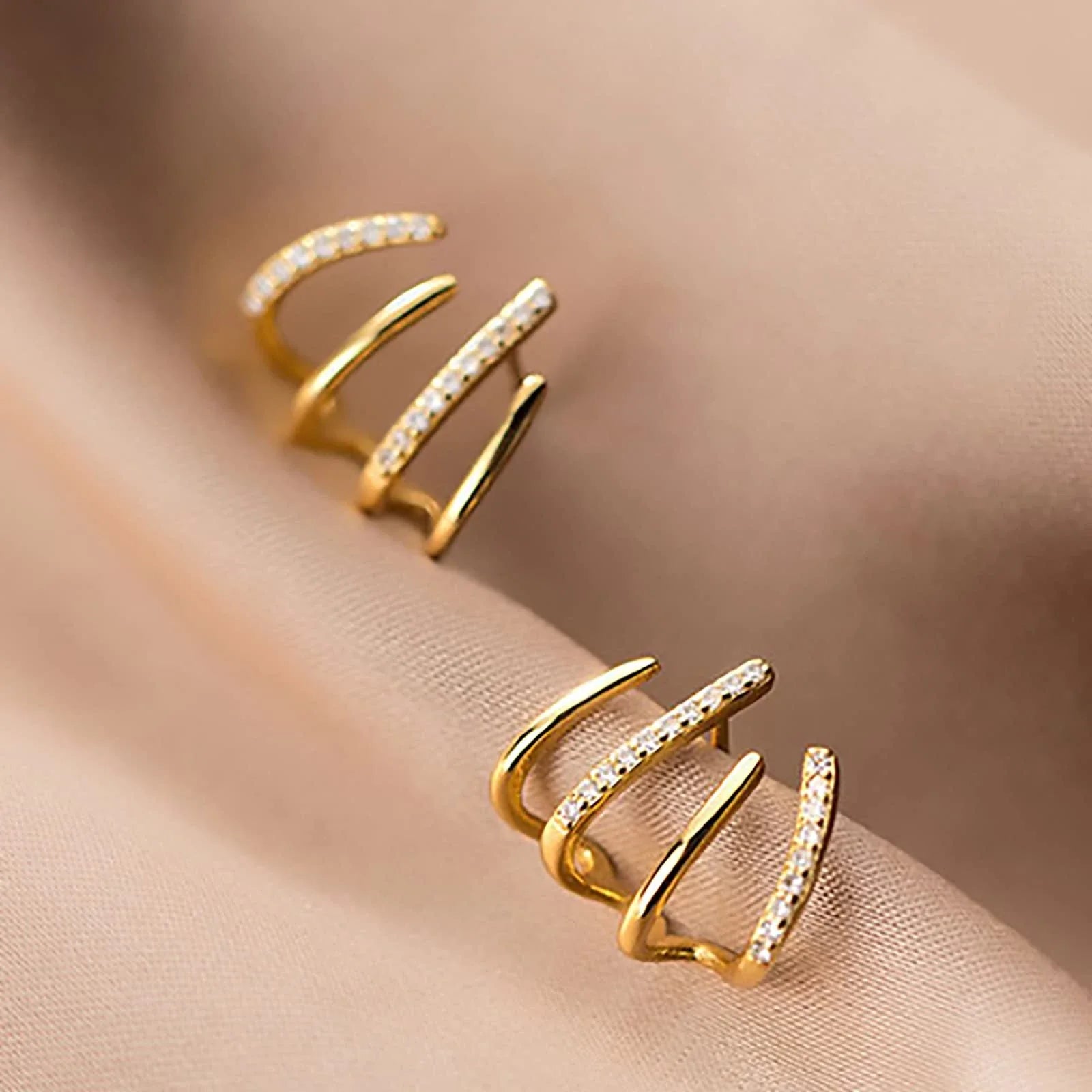 Exquisite zircon four-claw stud earrings in a gleaming gold colour, showcasing a timeless and elegant design