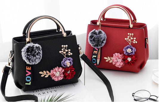 Elegant leather tote bag with delicate flower embellishments, perfect for modern British fashion