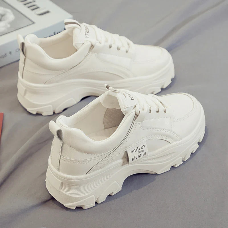 Fashionable women's casual trainers in beige and white colours, featuring a sporty yet chic design for everyday wear.