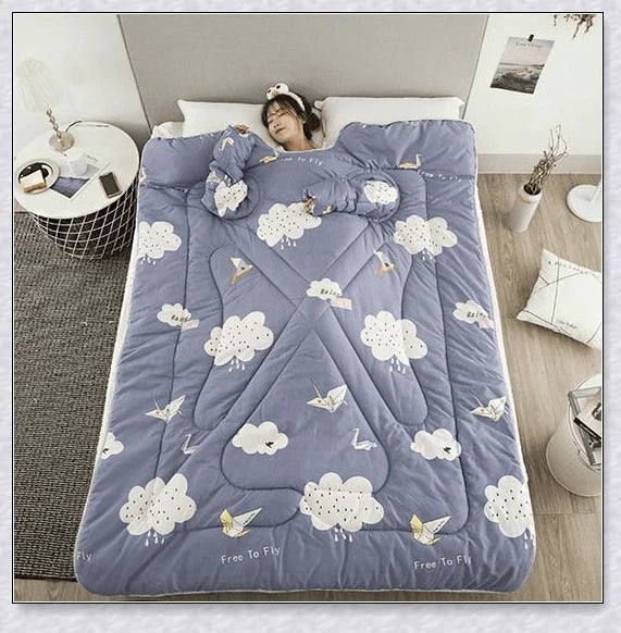 A cosy, wearable quilt with sleeves in a variety of colourful designs, perfect for staying warm and comfortable during the winter months.