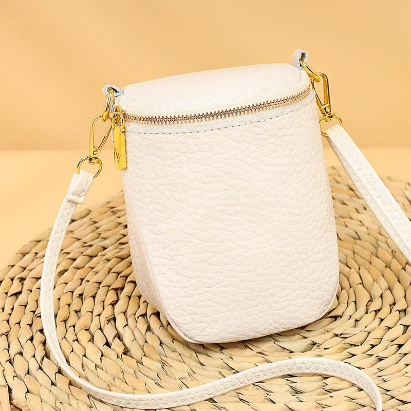 Elegant leather crossbody bag with adjustable strap, multiple pockets, and premium cowhide construction for the modern British woman