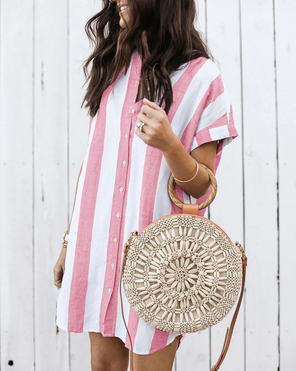 Casual striped short sleeve shirt dress in pink and blue colours, featuring a relaxed, flowing silhouette and button-down closure