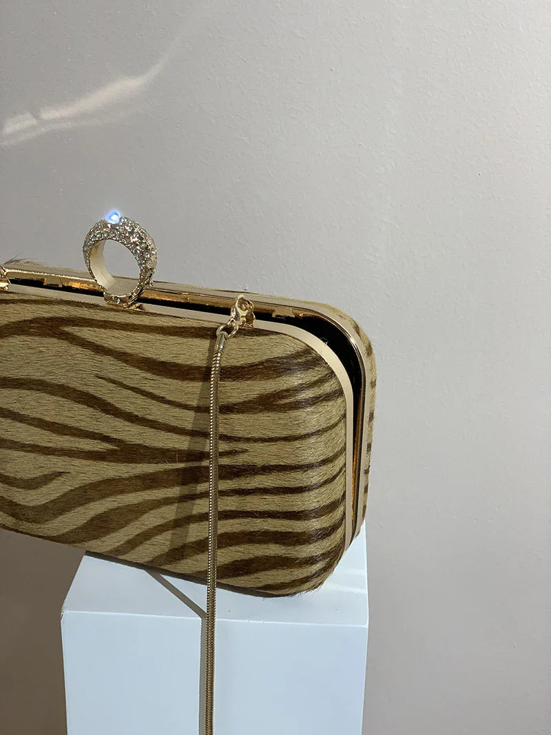 A premium handcrafted messenger bag made with luxurious horsehair and featuring a unique colourful brick ring buckle closure, showcasing the timeless charm of British craftsmanship.