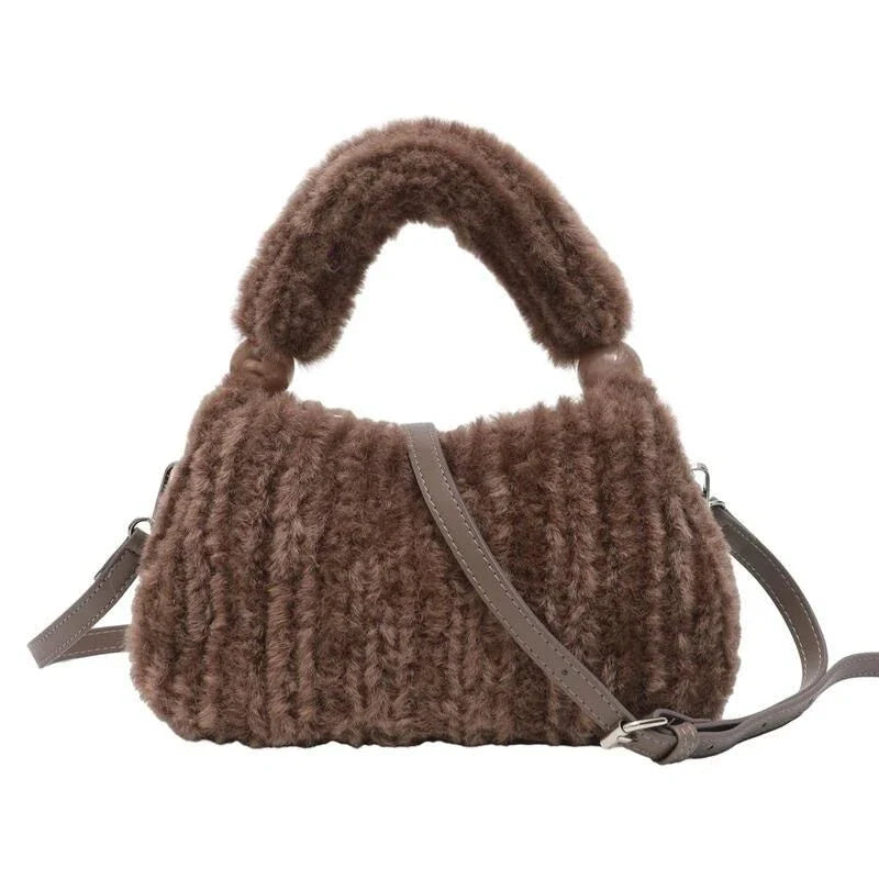 A luxurious faux fur hobo handbag with a stylish baguette shape and secure zipper closure