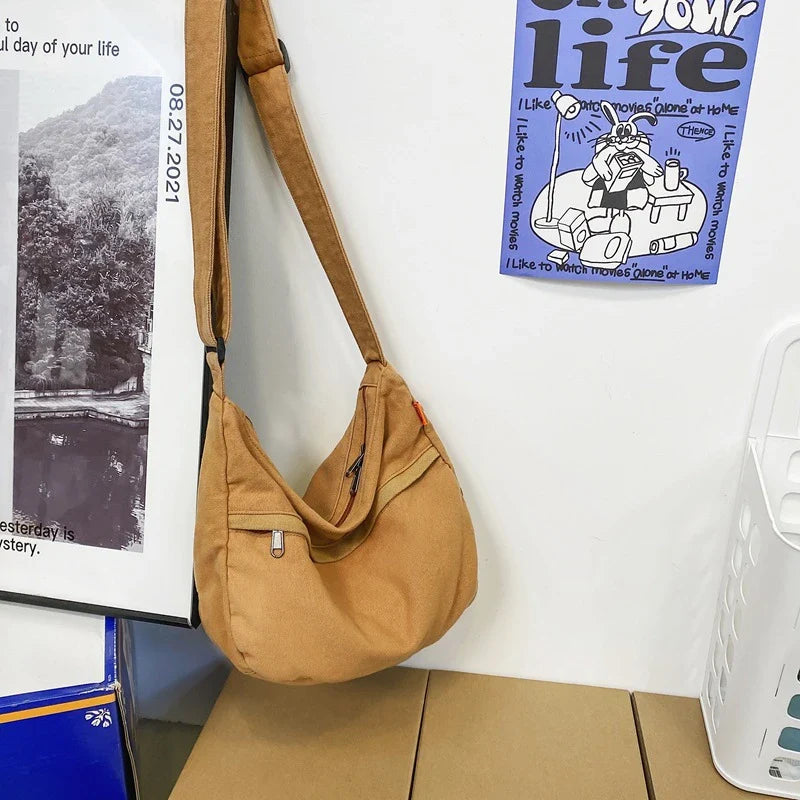A stylish and durable canvas tote bag with a spacious interior and a timeless vintage-inspired design, perfect for everyday use and travel
