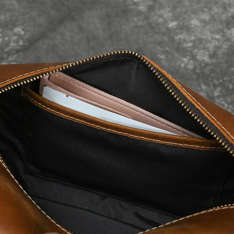 Premium leather clutch bag with multiple interior pockets, designed for the sophisticated British gentleman