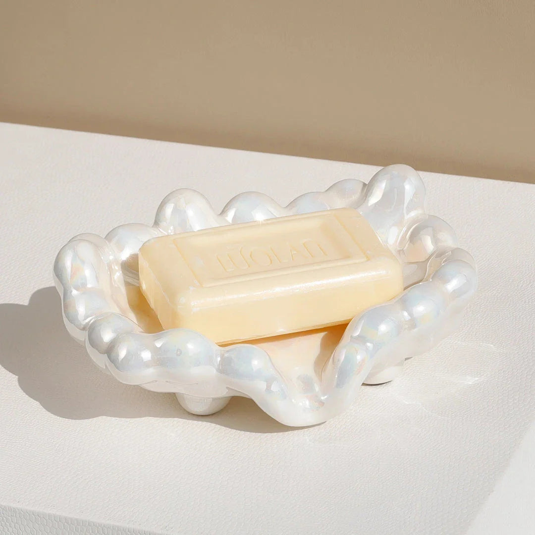 A ceramic soap dish with a whimsical cloud design, perfect for elevating your bathroom decor.