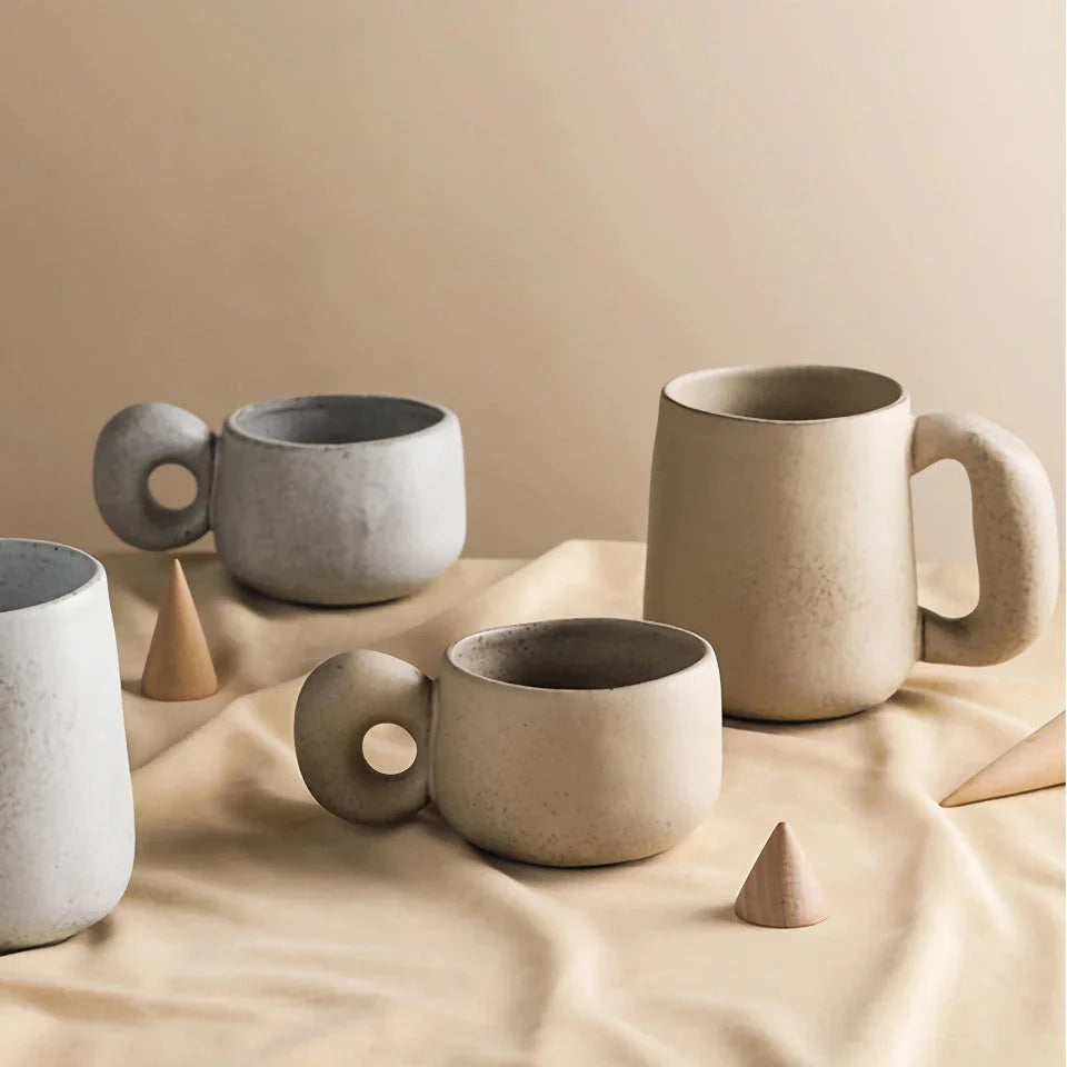 Handcrafted Japanese ceramic retro coffee mug in solid apricot or grey colour, featuring a comfortable handgrip design for enhanced daily beverage enjoyment.