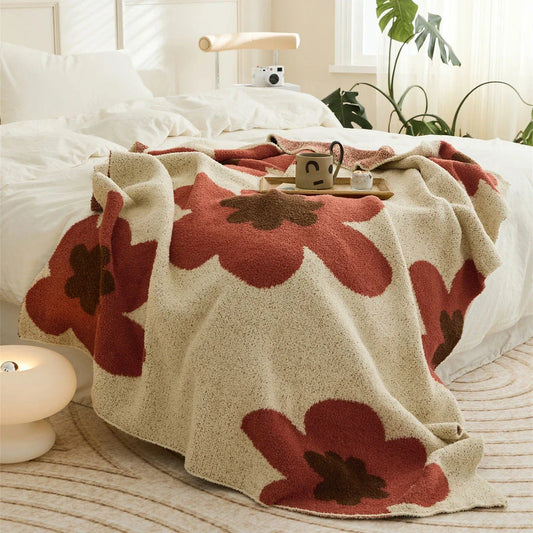 Cosy floral knitted throw blanket in red, featuring a chic bohemian design and luxurious microfibre fabric for maximum comfort and style.