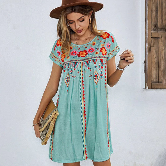 A stylish bohemian-inspired short dress with a geometric pattern, A-line silhouette, and short sleeves, suitable for warm weather