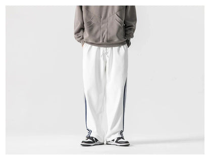 Stylish striped sports trousers in a relaxed, mid-waist design for versatile leisure and athletic wear