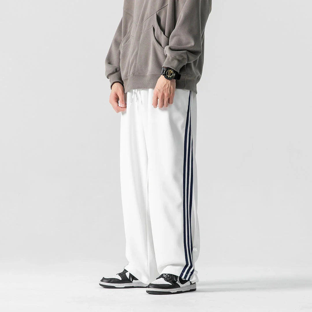 Stylish striped sports trousers in a relaxed, mid-waist design for versatile leisure and athletic wear