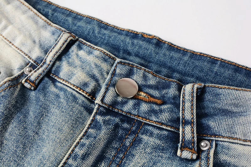 Stylish distressed denim jeans with a skinny, knee-exposed silhouette for a contemporary, high-street fashion look
