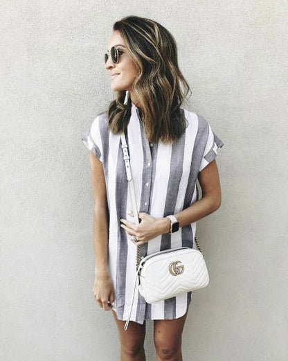Casual striped short sleeve shirt dress in pink and blue colours, featuring a relaxed, flowing silhouette and button-down closure