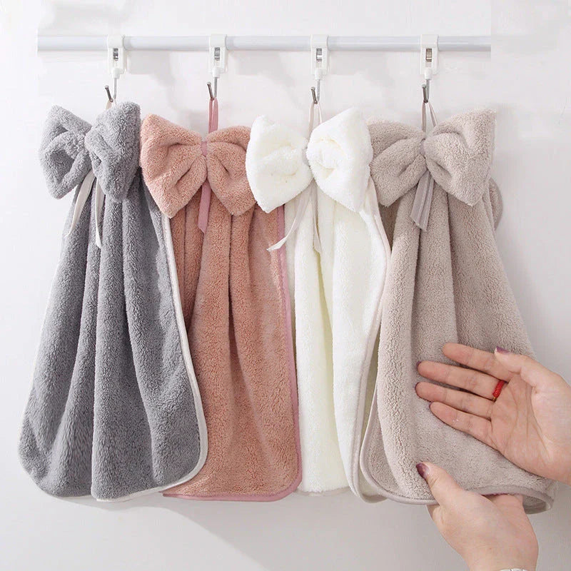 Elegant coral fleece hand towels with a unique bow design, perfect for kitchen and bathroom use