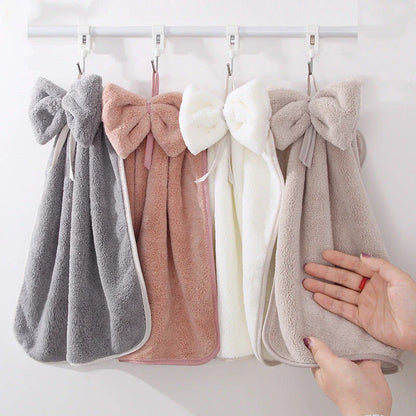 Elegant coral fleece hand towels with a unique bow design, perfect for kitchen and bathroom use