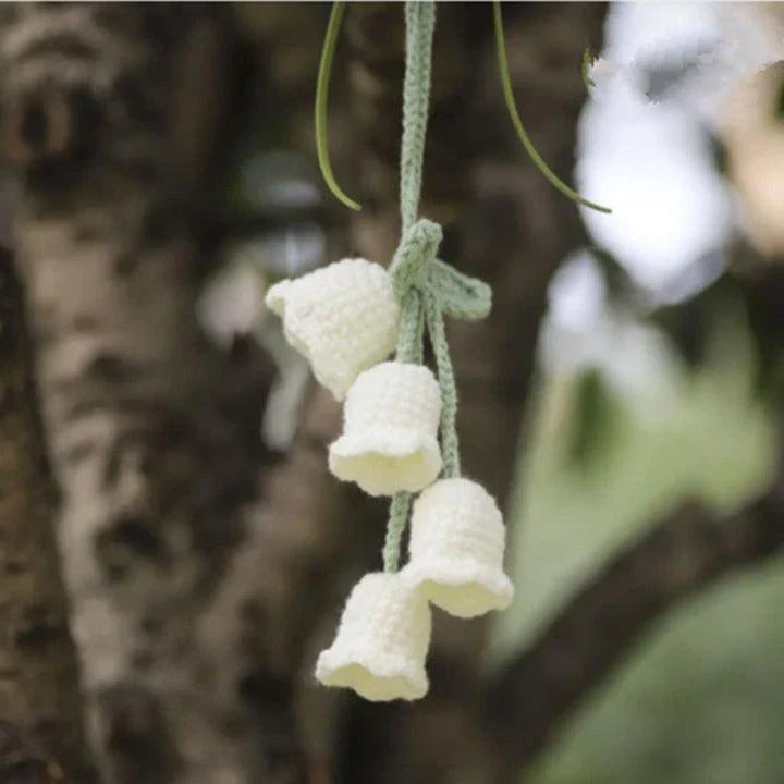 Charming knitted car plant decor with hanging white rope and green and white colour scheme