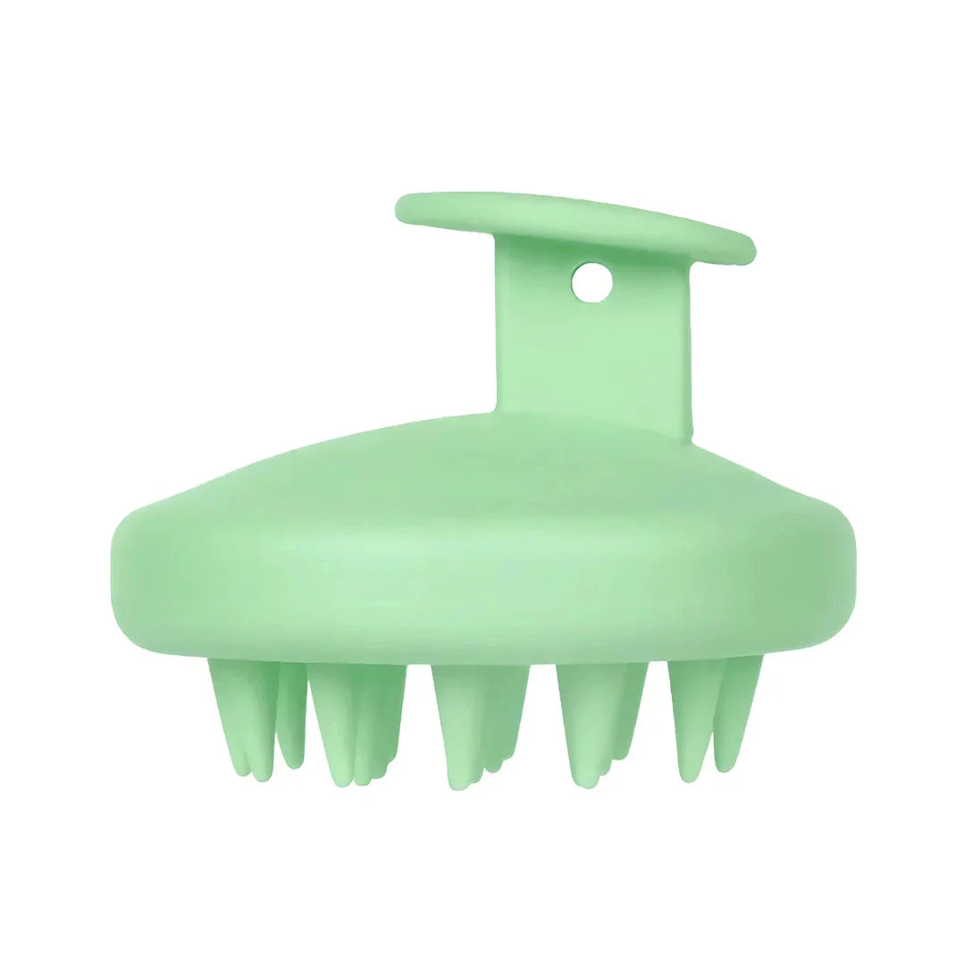 A green silicone scalp massager with soft bristles, designed to provide a soothing hair washing experience and promote healthy hair growth.