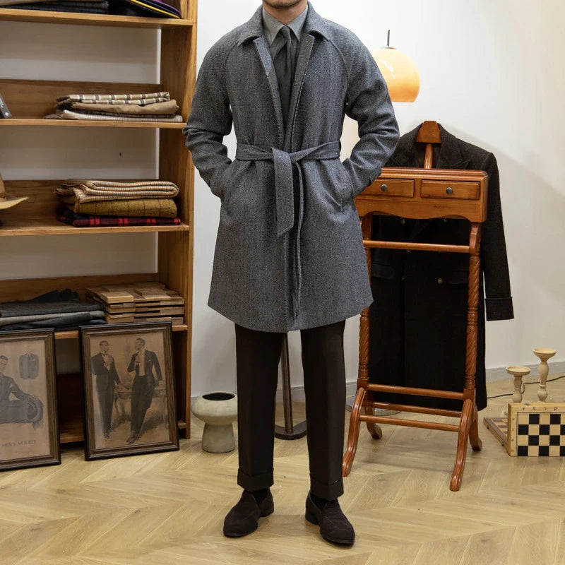 Premium mid-length herringbone wool coat in a sophisticated dark grey hue, featuring a tailored slim-fit silhouette for a refined, stylish appearance.