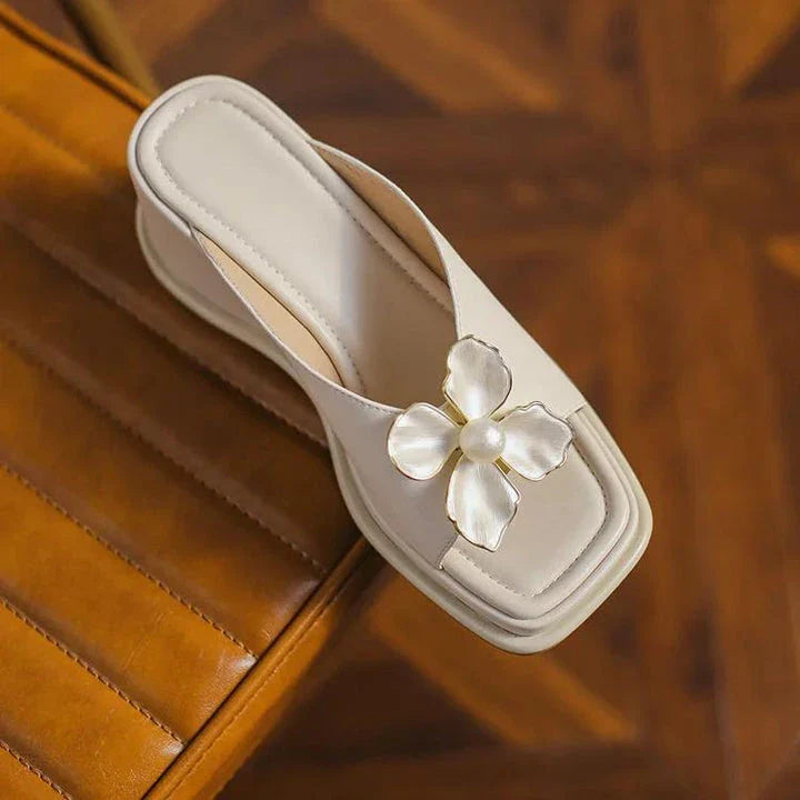 Elegant pearl flower wedge sandals in beige colour, featuring a thick, cushioned platform and adjustable straps for a comfortable fit.