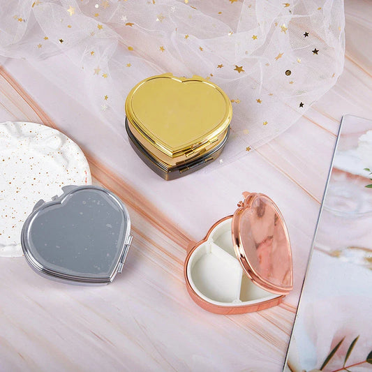 Elegant heart-shaped metal pill box with mirror for organized storage and convenient touch-ups