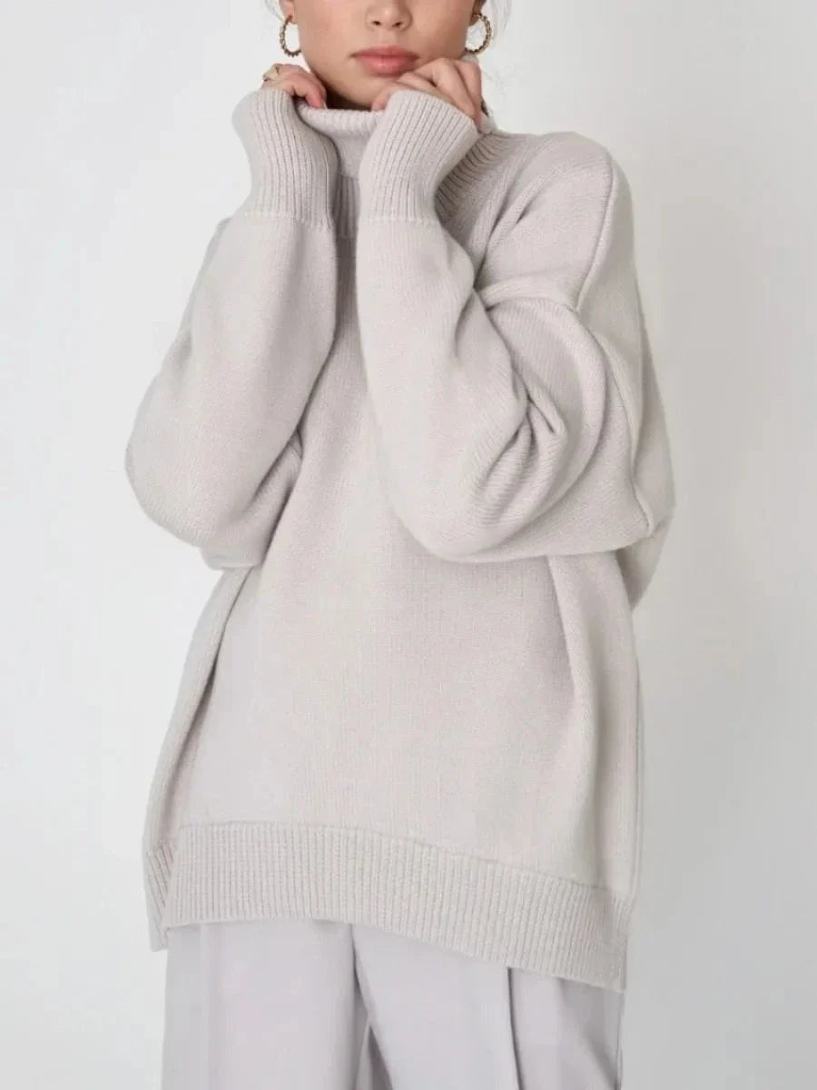 Cosy oversized knitted pullover in blue, featuring a classic turtleneck collar and drop-shoulder silhouette for maximum comfort and style.