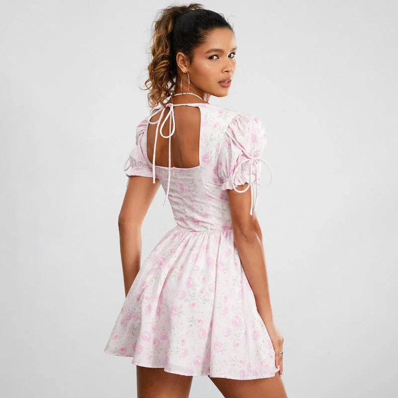 Floral mini dress with puff sleeves, featuring a V-neck, backless design, and A-line silhouette in a vibrant floral print