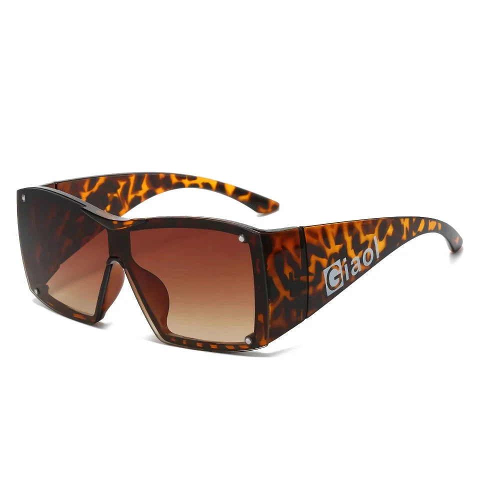 Oversized square sunglasses with black lenses and a durable plastic frame, offering UV400 protection and adaptive photochromic technology.