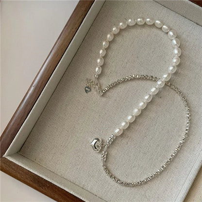 Elegant heart-shaped pearl necklace in sterling silver, a timeless British-inspired accessory