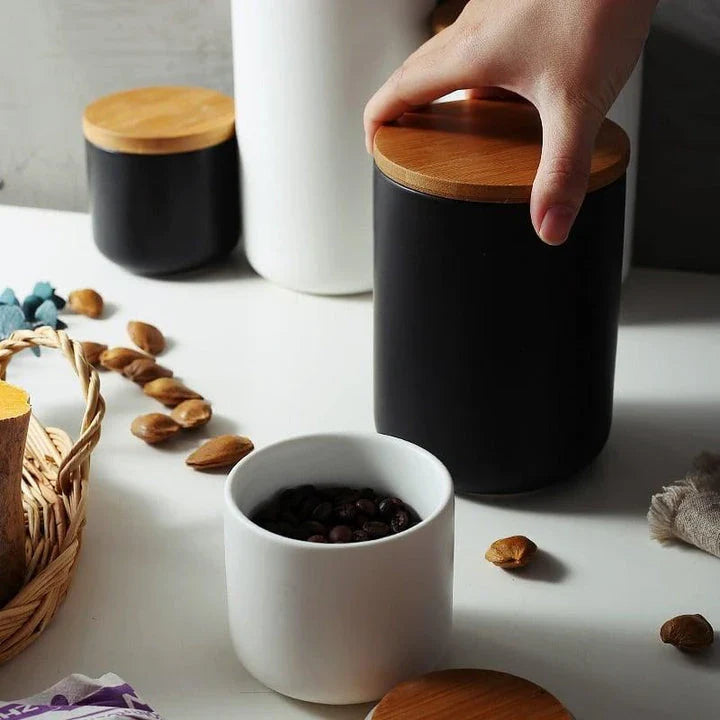 Elegant ceramic storage jars with airtight lids, available in small, medium, and large sizes for versatile kitchen organisation.