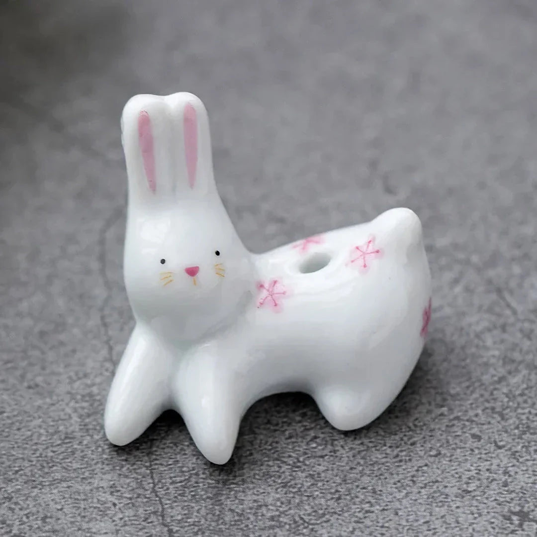 Charming Japanese-style ceramic incense holder with a playful rabbit and kitten design, perfect for creating a relaxing atmosphere in any room.