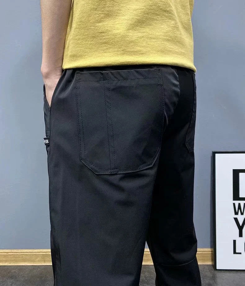 Premium slim-fit drawstring joggers in black and grey, featuring a tailored silhouette and adjustable waistband for a polished, comfortable look.