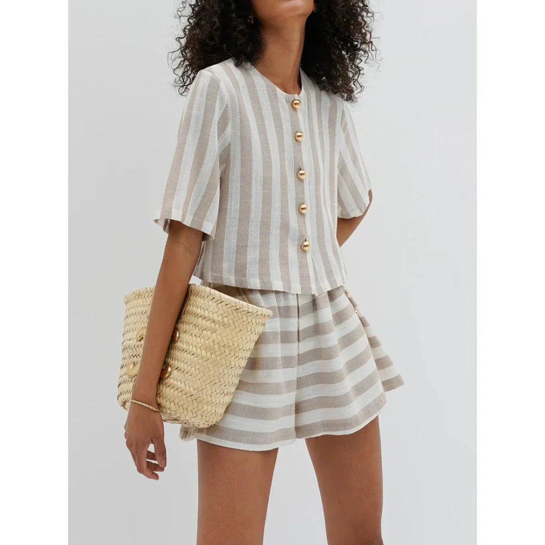 Relaxed and stylish two-piece summer outfit with a striped pattern, featuring a short-sleeved shirt and high-waist shorts.