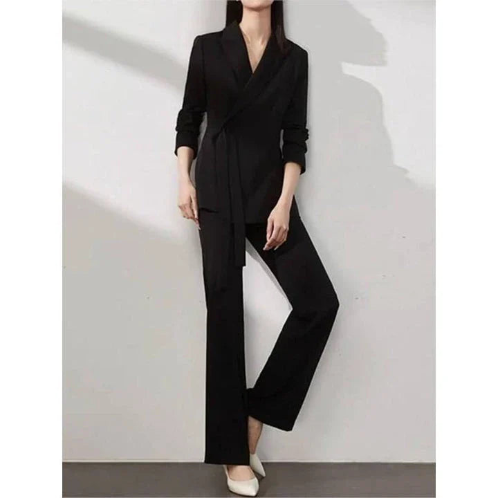 A two-piece vintage-inspired office suit with a long-sleeve blazer and high-waisted trousers, designed for the modern professional woman.