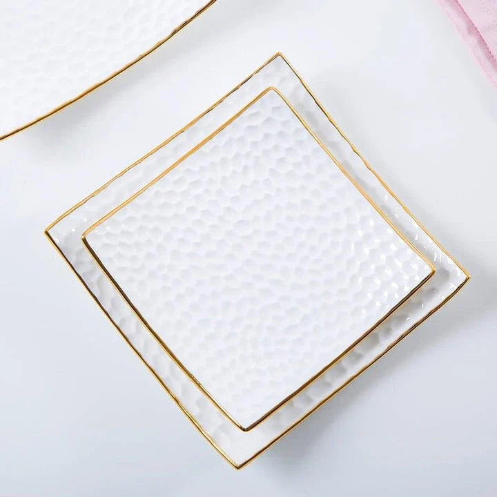 Elegant embossed ceramic cake plate in white, perfect for serving desserts and platters.