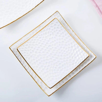 Elegant embossed ceramic cake plate in white, perfect for serving desserts and platters.