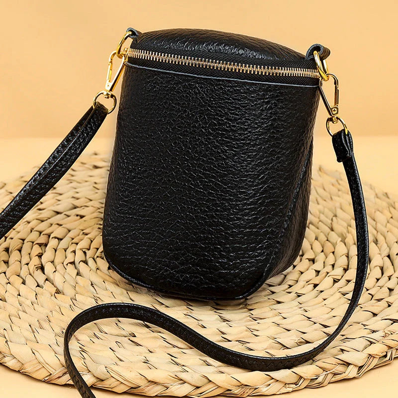 Elegant leather crossbody bag with adjustable strap, multiple pockets, and premium cowhide construction for the modern British woman