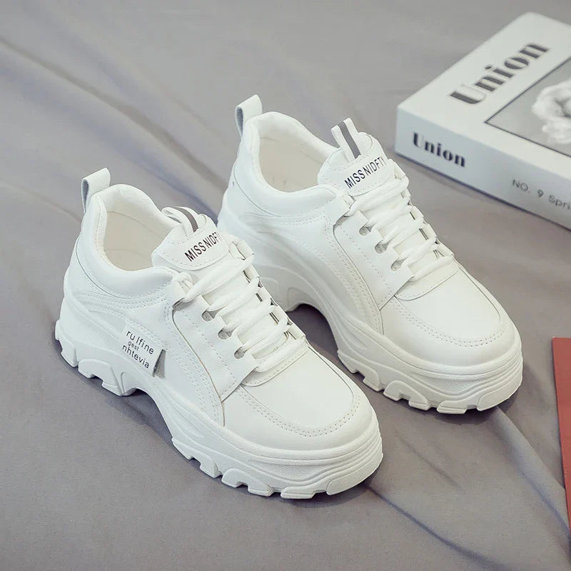 Fashionable women's casual trainers in beige and white colours, featuring a sporty yet chic design for everyday wear.