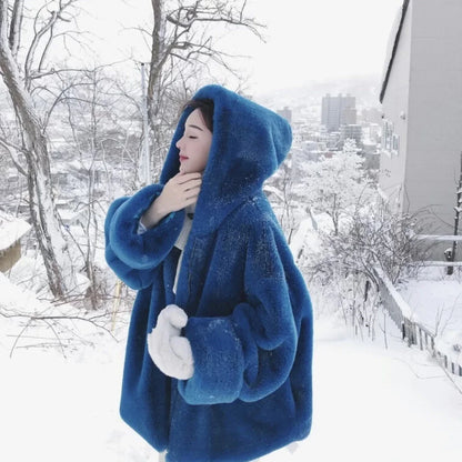 A stylish navy blue faux fur rabbit coat with a hooded design and medium length, perfect for staying warm and fashionable in the UK.
