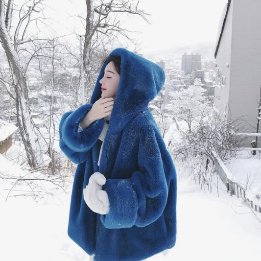 A stylish navy blue faux fur rabbit coat with a hooded design and medium length, perfect for staying warm and fashionable in the UK.