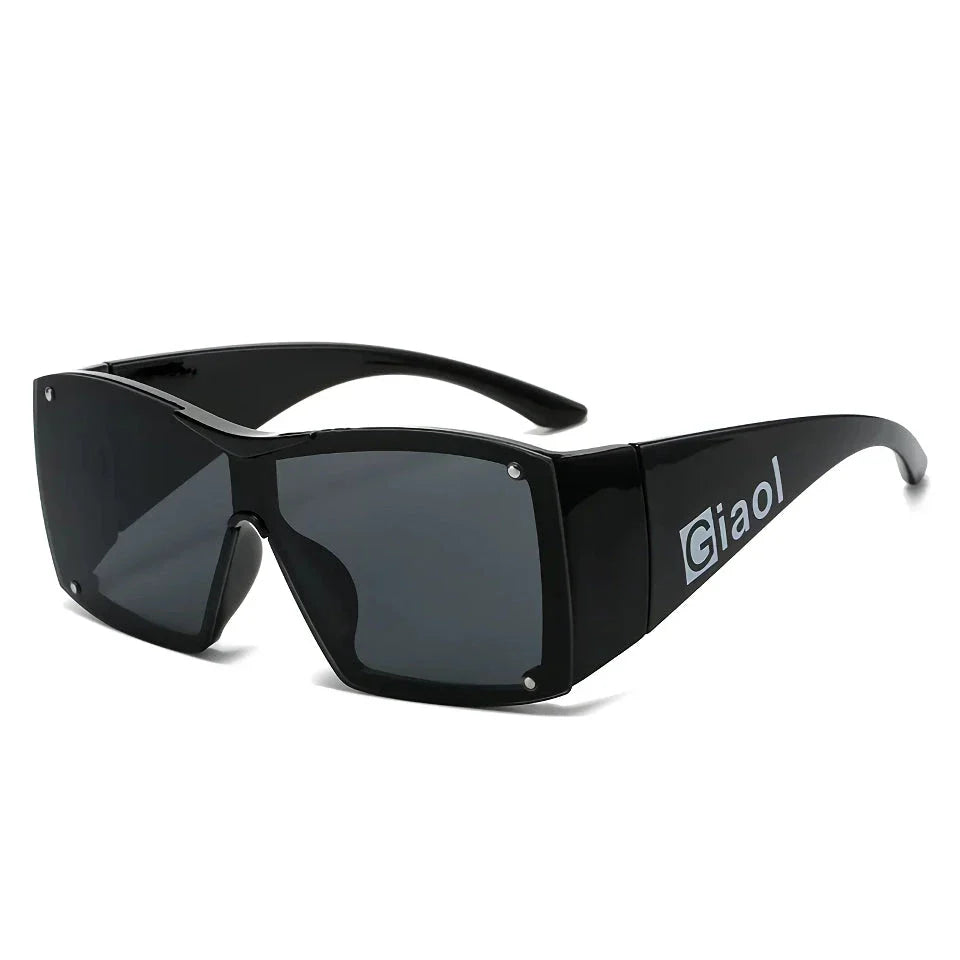 Oversized square sunglasses with black lenses and a durable plastic frame, offering UV400 protection and adaptive photochromic technology.