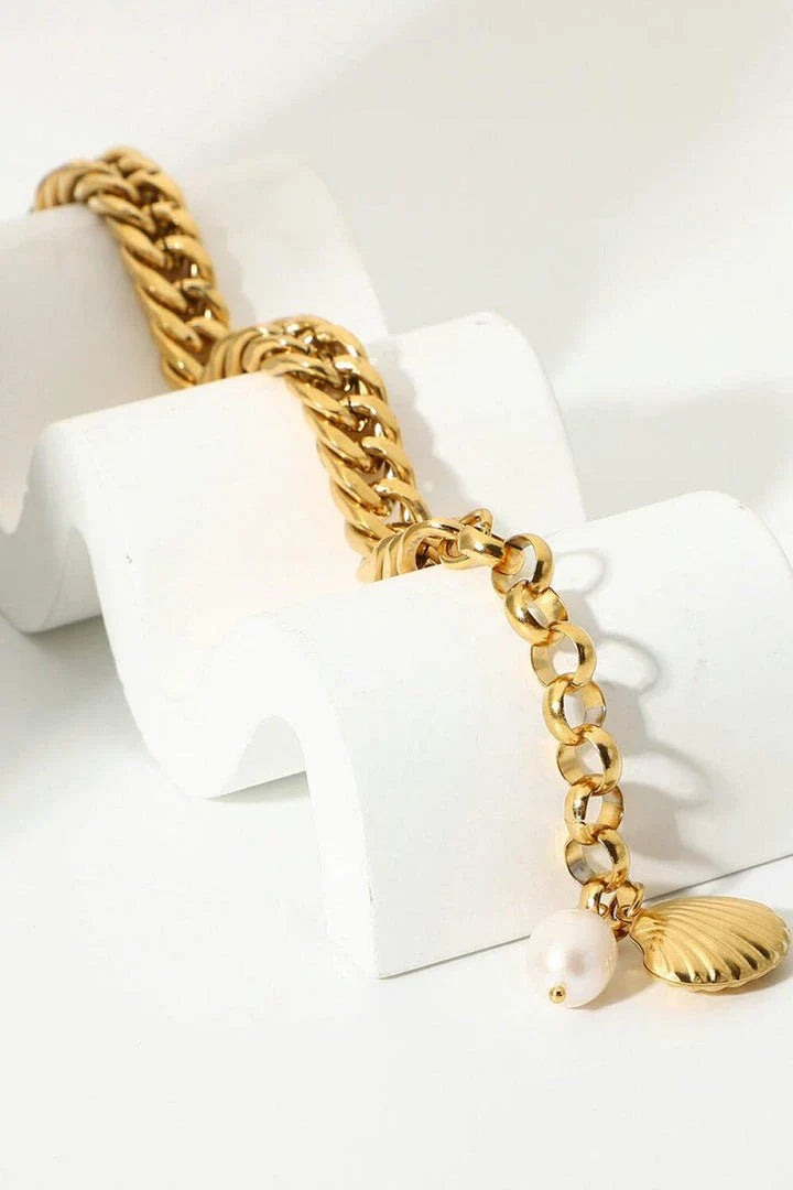 Elegant 18-carat gold-plated curb chain bracelet with a delicate pearl accent, showcasing premium British craftsmanship