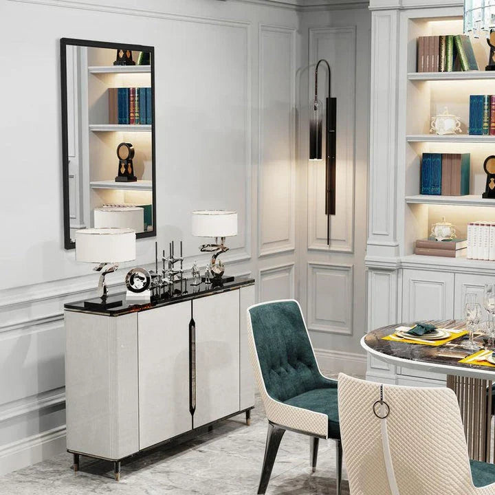 Sophisticated black metal framed wall mirror with rounded corners, reflecting a bright and spacious room